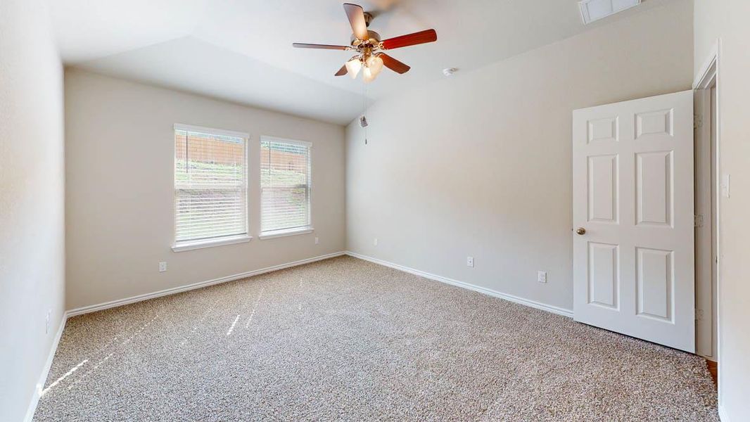 Spare room with light colored carpet, a ceiling fan, and lofted ceiling