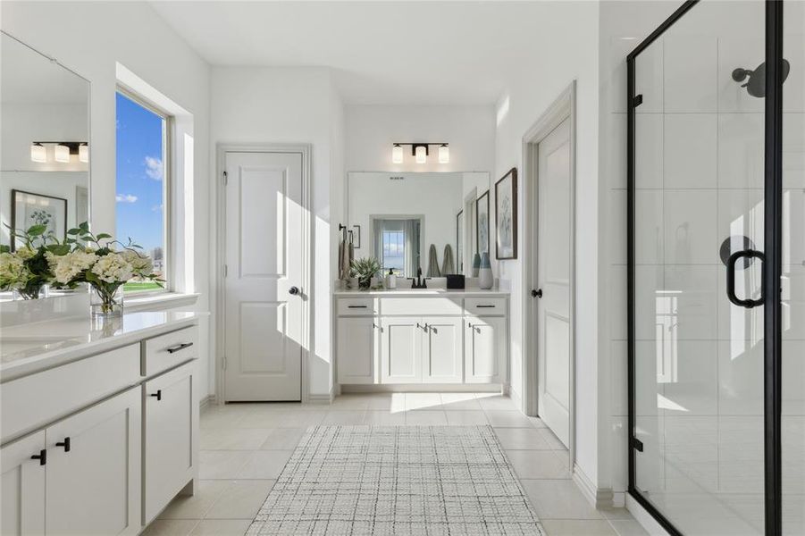 With separate vanities and an oversized walk in shower, you'll find plenty of space for 2 in this lovely owner's bath.