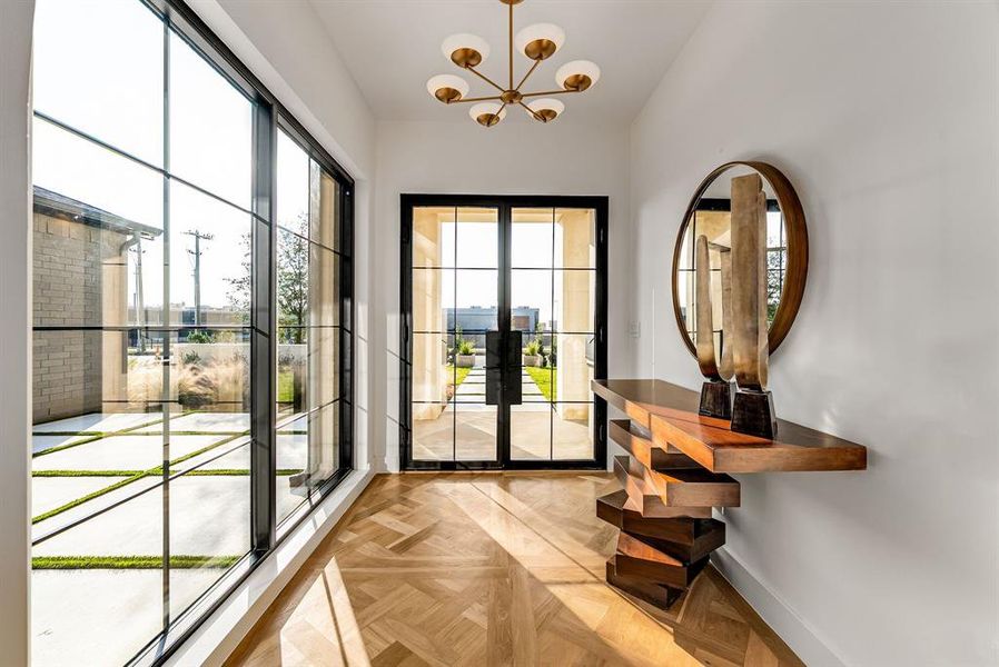 Doorway featuring baseboards and a chandelier Doorway featuring baseboards and a chandelier