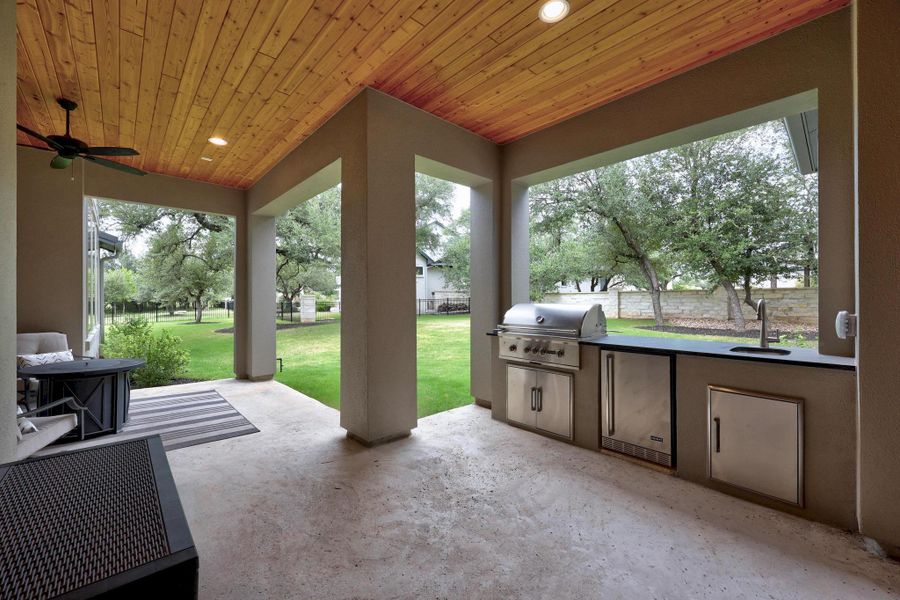 View of patio featuring area for grilling and a ceiling fan