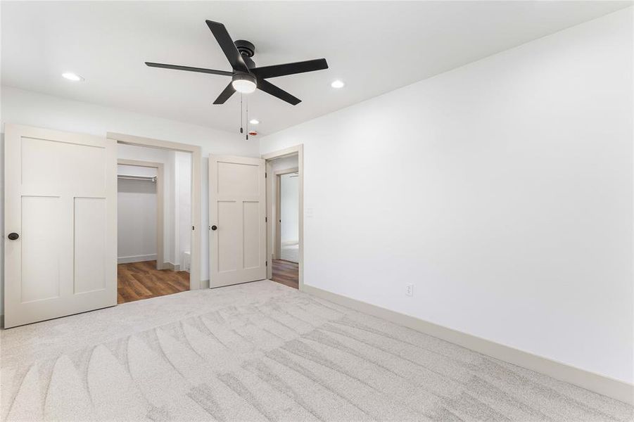 Unfurnished bedroom featuring carpet, ceiling fan, and recessed lighting Unfurnished bedroom featuring carpet, ceiling fan, and recessed lighting