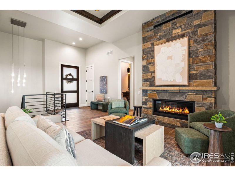 A stone fireplace warms the living room