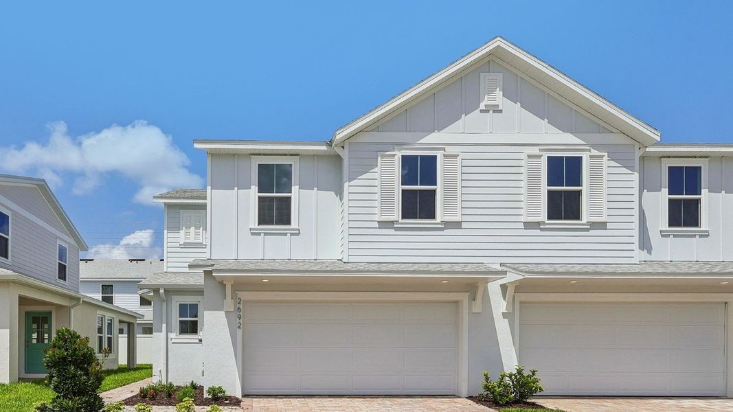 Front exterior of a new home in Cyrene at Harmony, St. Cloud, FL, highlighting curb appeal (Image 21). Front exterior of a new home in Cyrene at Harmony, St. Cloud, FL, highlighting curb appeal (Image 21).