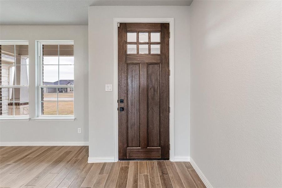 Foyer featuring wood finished floors and baseboards Foyer featuring wood finished floors and baseboards
