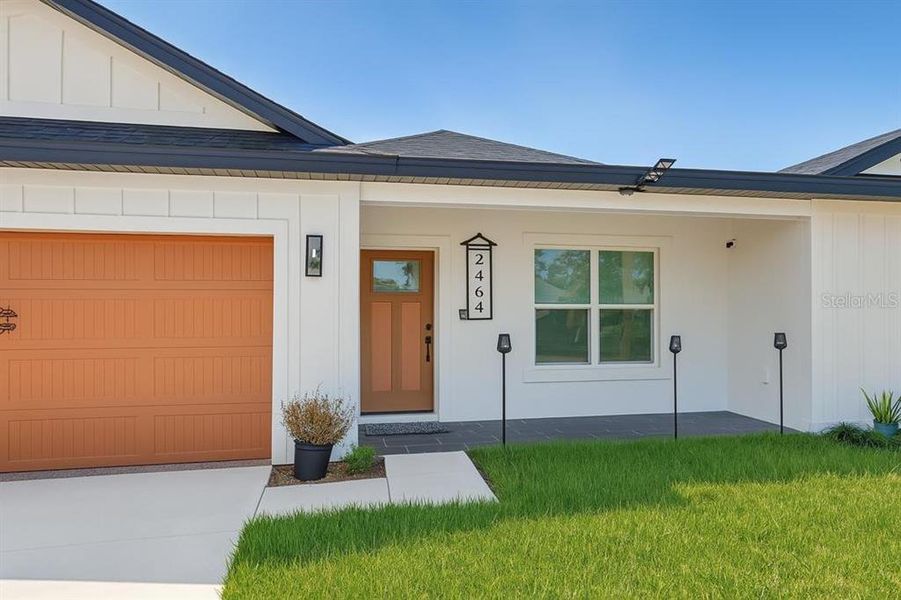Front exterior of a new home in , Deltona, FL, highlighting curb appeal (Image 23).