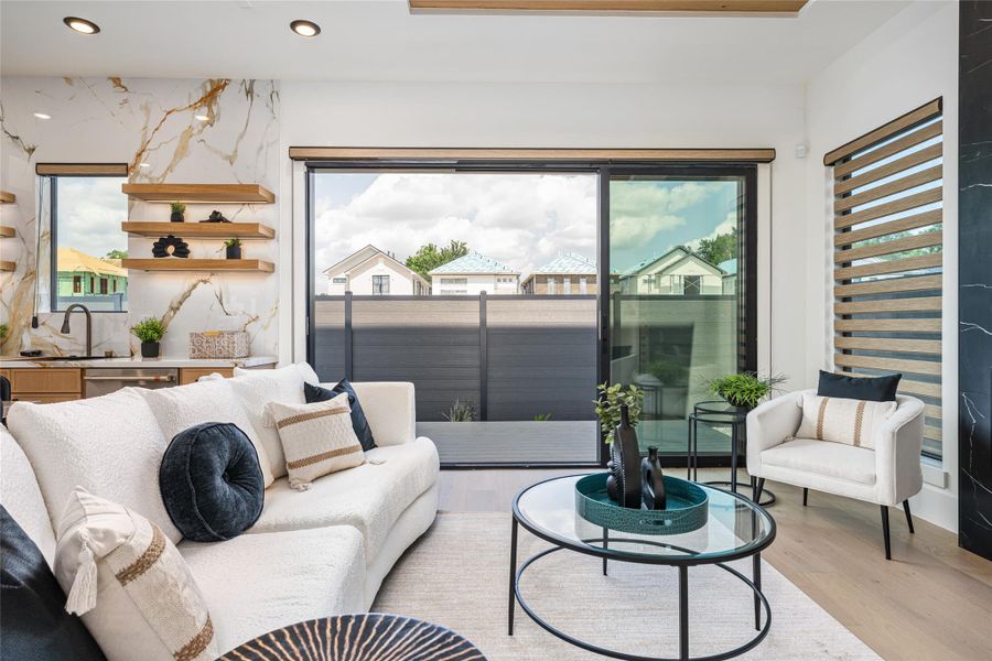 Expansive windows flood the living room with soft natural light, making every moment feel sunlit and serene Expansive windows flood the living room with soft natural light, making every moment feel sunlit and serene