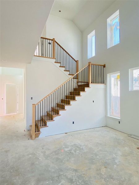 Grand Staircase & Family Room with soaring ceiling