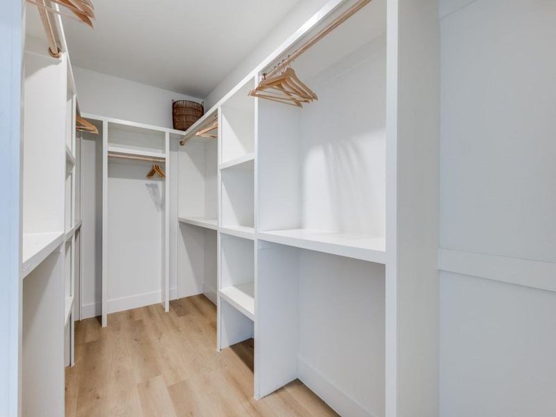 Generously-sized and well-designed walk-in closet for primary suite.