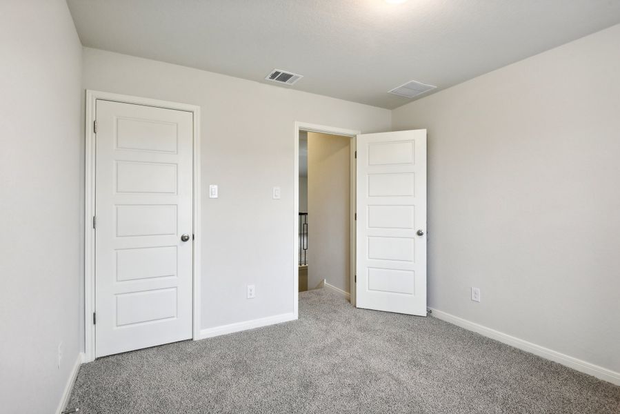 Guest bedroom in the Red River floorplan at a Meritage Homes community.