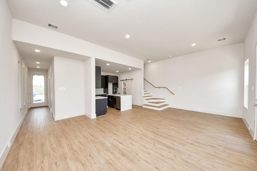 This open layout flows effortlessly from the living area into the modern kitchen.