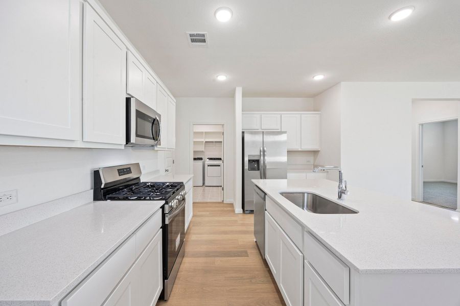 Kitchen in the Magnolia home plan by Trophy Signature Homes – REPRESENTATIVE PHOTO