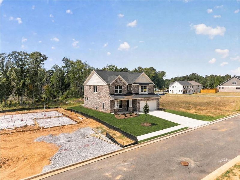 Front exterior of a new home in , Loganville, GA, highlighting curb appeal (Image 29).
