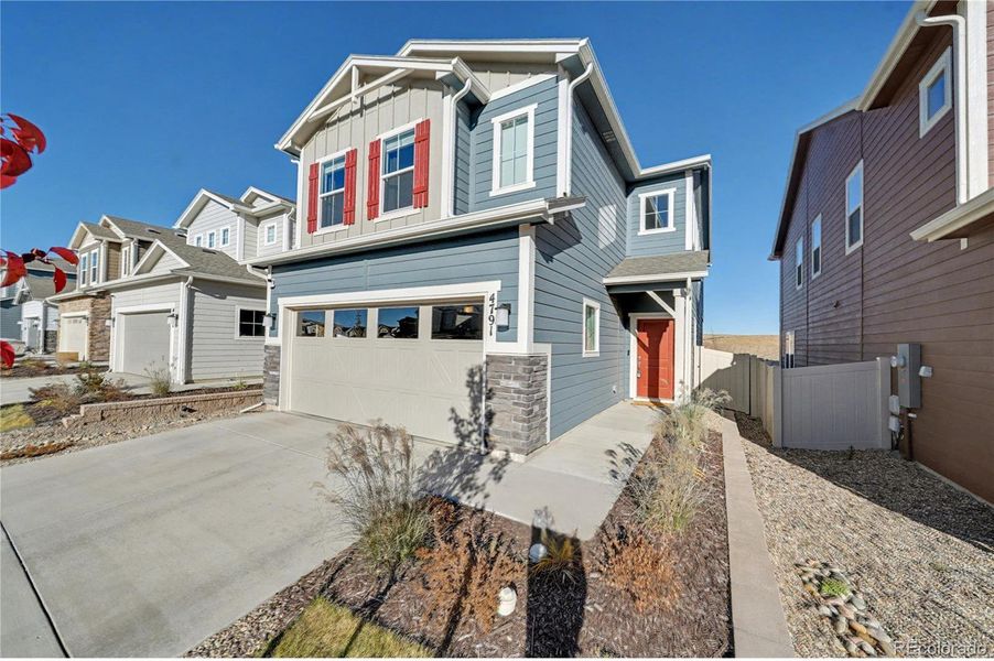 Front exterior of a new home in , Colorado Springs, CO, highlighting curb appeal (Image 1).