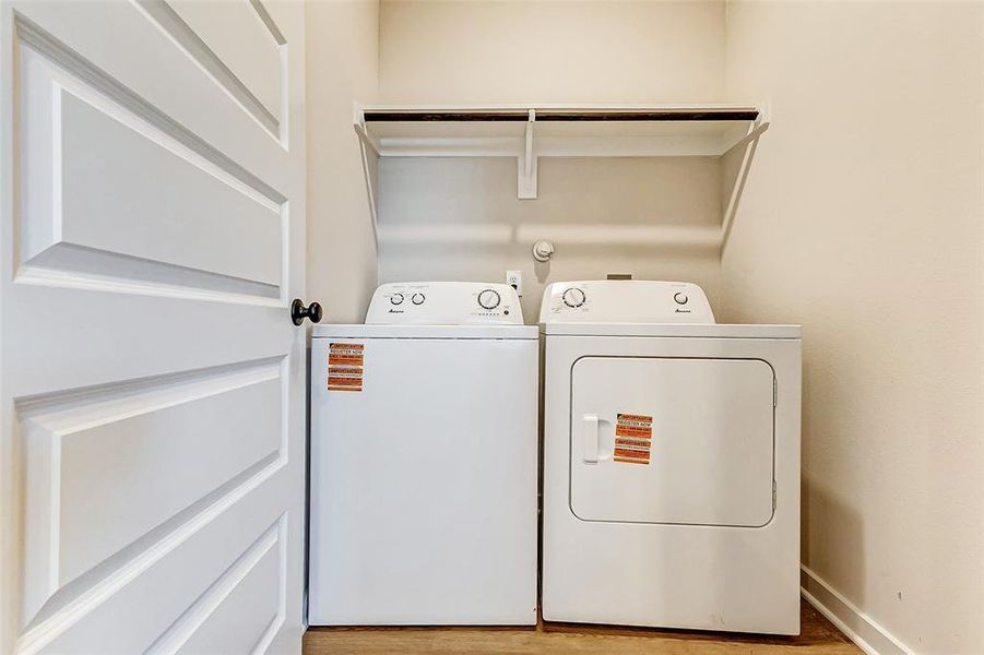 A functional laundry area with included washer and dryer offers convenience and practicality. Featuring overhead shelving for extra storage, this space is designed to simplify household chores. Its clean and organized layout ensures everything you need is within easy reach.