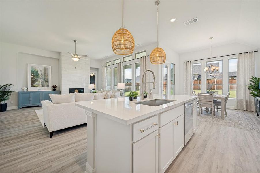 The heart of the home is this breathtaking open-concept living space, where a sprawling quartz island, designer lighting, soaring ceilings, and expansive windows create an exceptional environment for entertaining. Flooded with natural light and thoughtfully designed for modern living, the kitchen, dining, and family room flow together seamlessly, offering both elegance and functionality The heart of the home is this breathtaking open-concept living space, where a sprawling quartz island, designer lighting, soaring ceilings, and expansive windows create an exceptional environment for entertaining. Flooded with natural light and thoughtfully designed for modern living, the kitchen, dining, and family room flow together seamlessly, offering both elegance and functionality