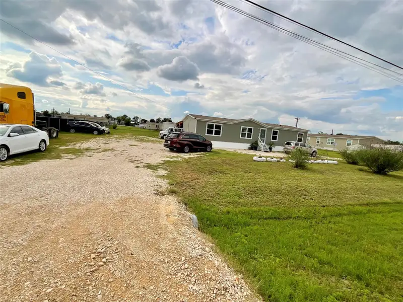Gray manufactured home with white trim and multiple windows
