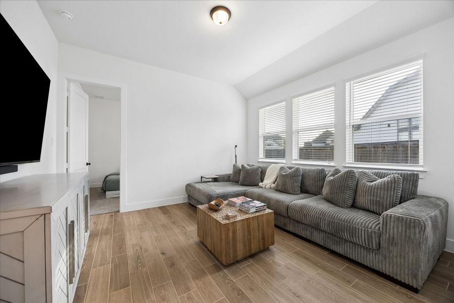 Versatile game room positioned off the secondary bedrooms, offering a flexible space for media, play, or a second living area. Vaulted ceiling and a row of windows keep the room feeling open and bright. Versatile game room positioned off the secondary bedrooms, offering a flexible space for media, play, or a second living area. Vaulted ceiling and a row of windows keep the room feeling open and bright.