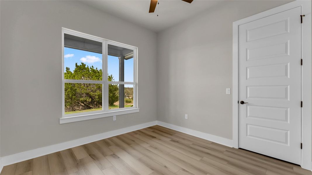 Unfurnished room featuring ceiling fan and light wood-style floors