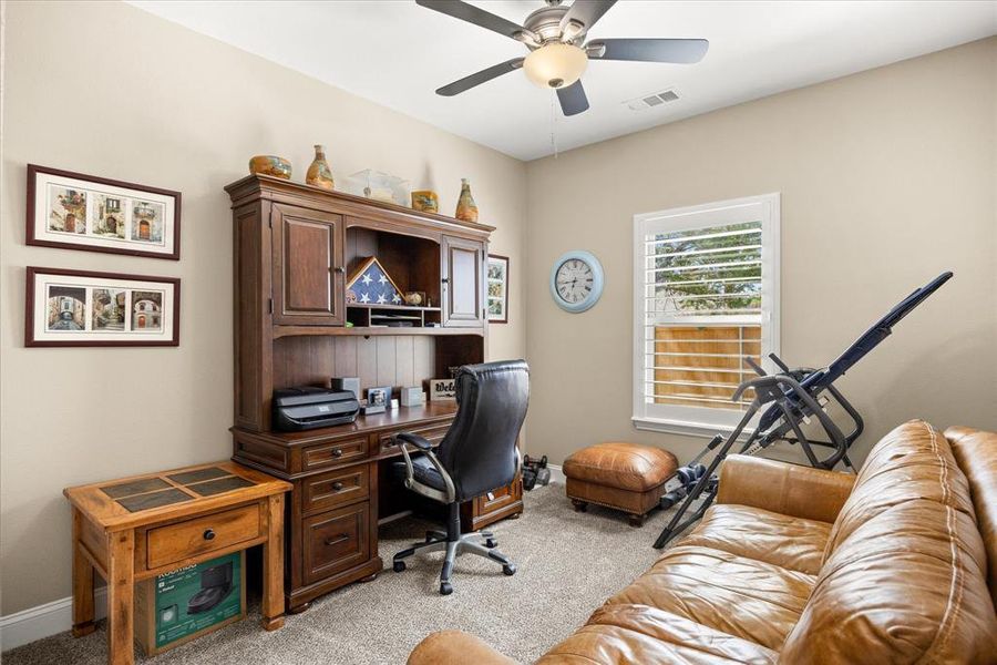Home office with light colored carpet and ceiling fan Home office with light colored carpet and ceiling fan