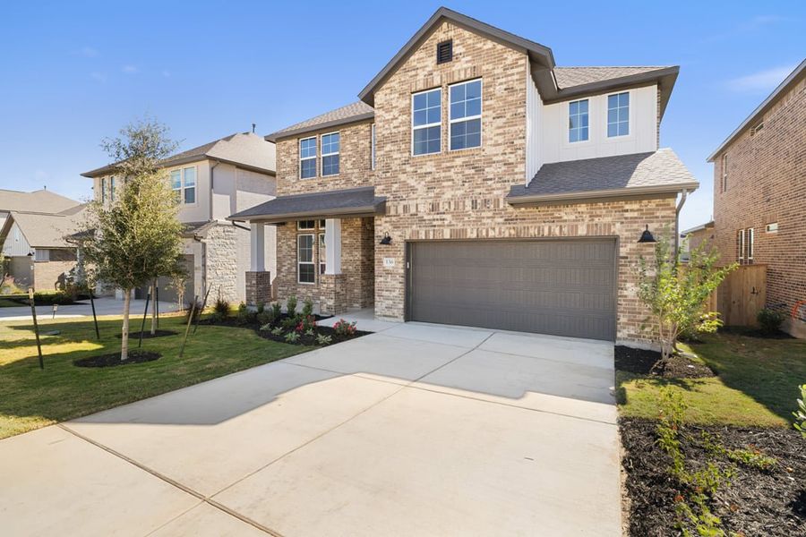 Front exterior of a new home in Park Collection at Lariat, Liberty Hill, TX, highlighting curb appeal (Image 28).