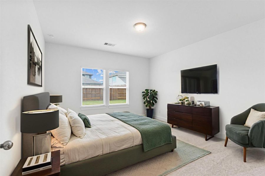 Spacious primary suite featuring plush carpet, soft neutral tones, and a large window for natural light — a peaceful retreat at the end of the day. *Virtually Staged* **Image Representative of Plan Only and May Vary as Built**.