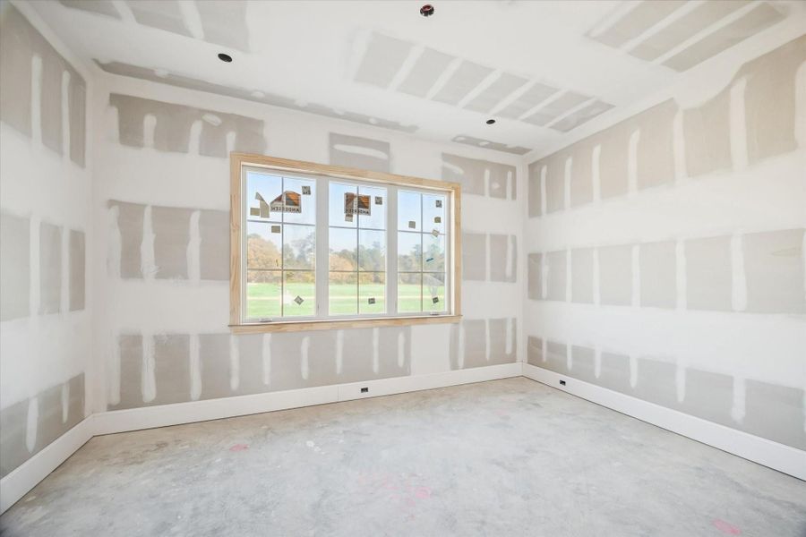 This secondary bedroom offers a bright, comfortable layout with multiple windows that bring in soft, natural light. The clean framing and drywall work create a solid foundation for upcoming trim and finish selections. A versatile space ideal for family, guests, or a future study.