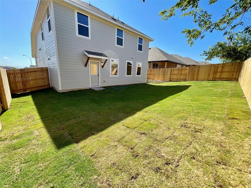 Front exterior of a new home in Covered Bridge, Hutto, TX, highlighting curb appeal (Image 23). Front exterior of a new home in Covered Bridge, Hutto, TX, highlighting curb appeal (Image 23).