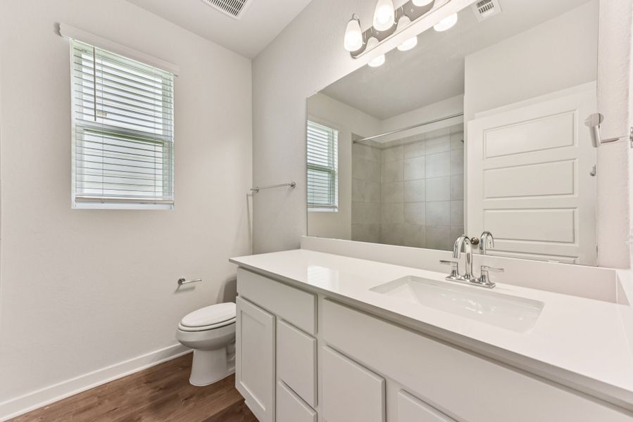 A bathroom with a large mirror.