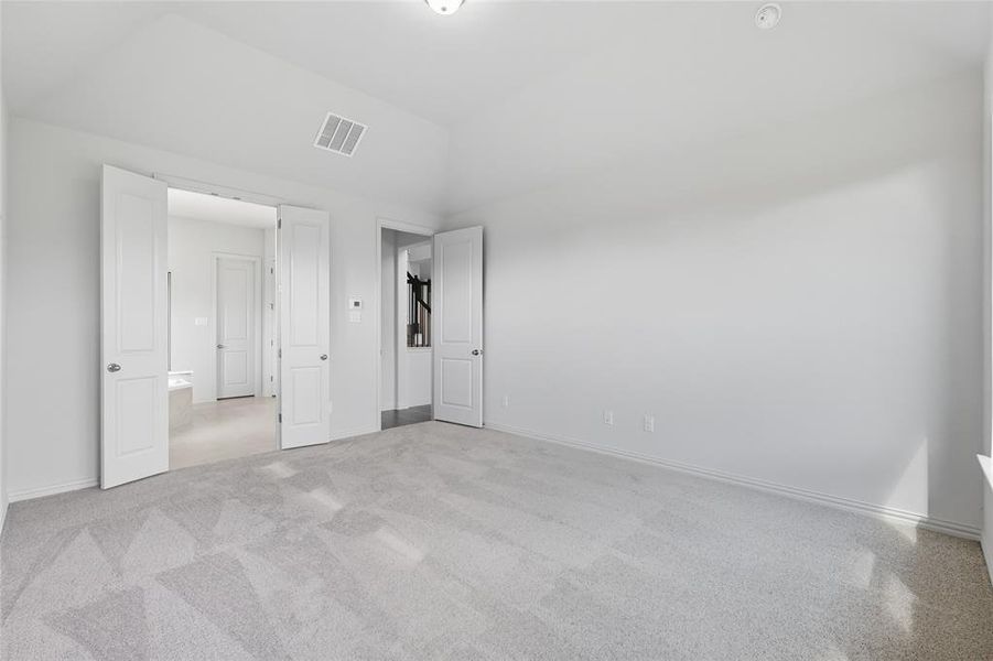 Unfurnished bedroom featuring baseboards and light carpet Unfurnished bedroom featuring baseboards and light carpet