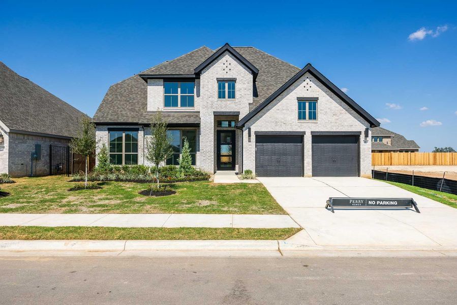 View of front of home featuring brick siding, roof with shingles, driveway, and a garage View of front of home featuring brick siding, roof with shingles, driveway, and a garage