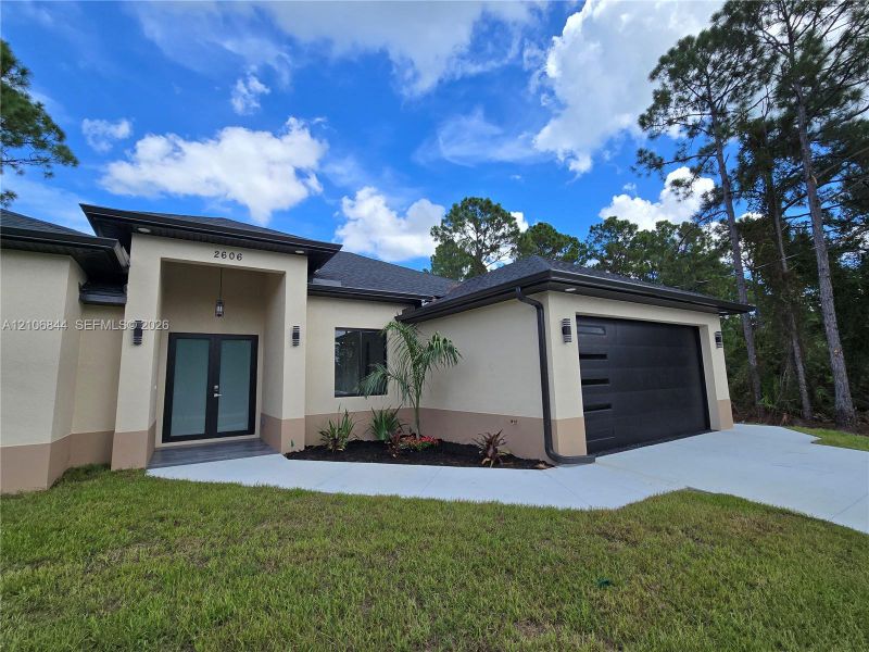 Front exterior of a new home in , Lehigh Acres, FL, highlighting curb appeal (Image 19). Front exterior of a new home in , Lehigh Acres, FL, highlighting curb appeal (Image 19).