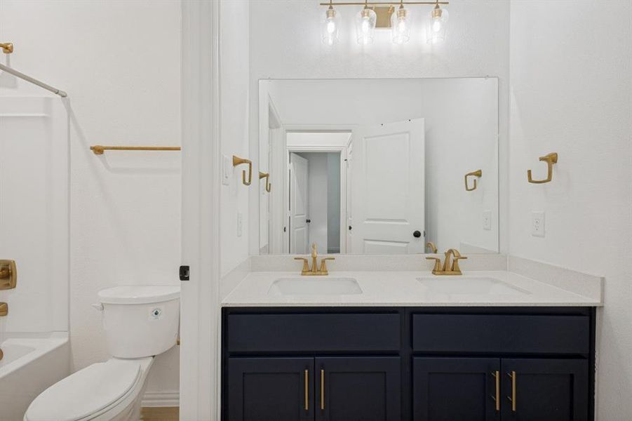Dual vanity with a white countertop and dark cabinetry