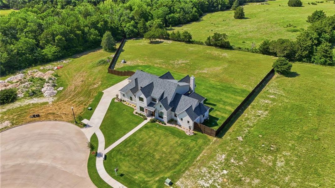 Contemporary home with multiple gables and dormers, set on a manicured lawn
