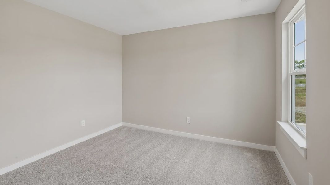 Bedroom with walk-in closet and window Bedroom with walk-in closet and window