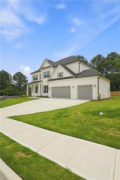 Front exterior of a new home in The Stables at Ewing Chapel, Dacula, GA, highlighting curb appeal (Image 27).
