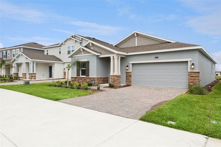 Front exterior of a new home in Wellness Ridge, Clermont, FL, highlighting curb appeal (Image 28). Front exterior of a new home in Wellness Ridge, Clermont, FL, highlighting curb appeal (Image 28).
