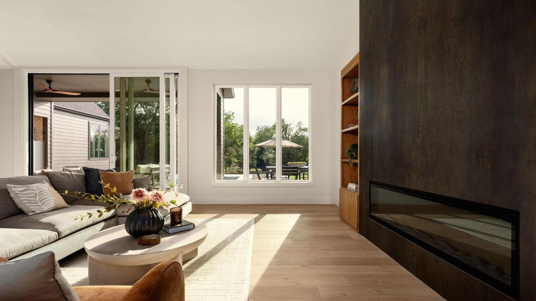 Hardwood floors and an integrated fireplace elevate this sun-drenched living space. Hardwood floors and an integrated fireplace elevate this sun-drenched living space.