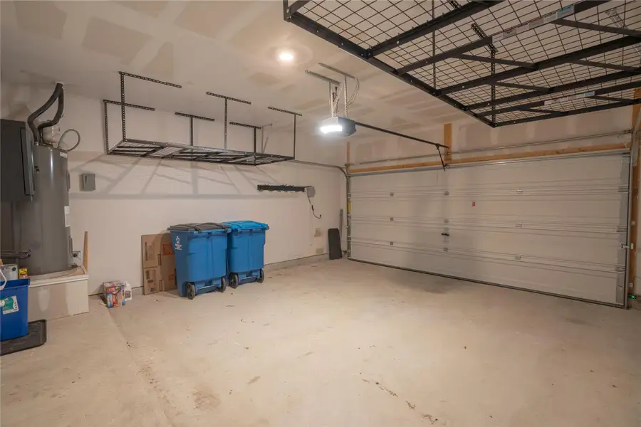 Secure parking and ample overhead storage provide convenience in this functional garage. Secure parking and ample overhead storage provide convenience in this functional garage.