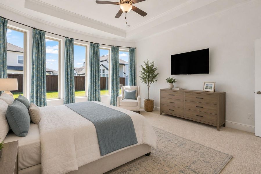 Your spacious primary bedroom features recessed ceiling and a bay style window, bringing ample natural light. This photo has been virtually staged to assist with viewers perspective.