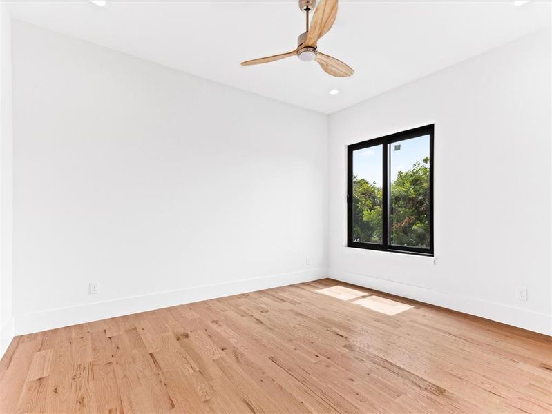 Spare room featuring ceiling fan and light hardwood / wood-style flooring