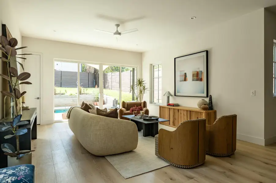 Hardwood floors and sliding glass doors define this airy living space opening to the backyard. Hardwood floors and sliding glass doors define this airy living space opening to the backyard.