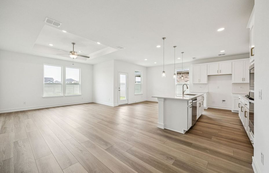 Gathering room drenched in natural light, creating a warm atmosphere  *Real home pictured