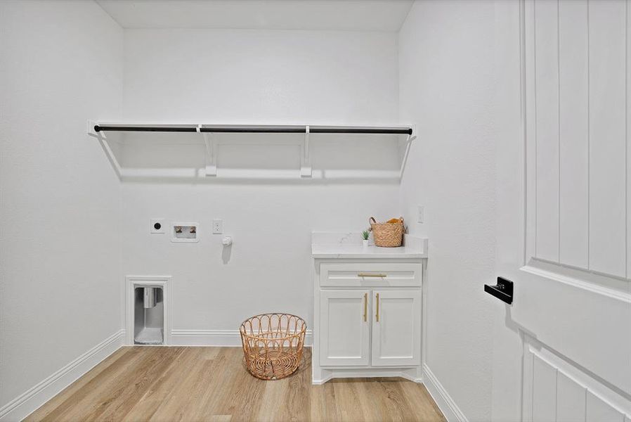 Clothes washing area featuring washer hookup, light hardwood / wood-style flooring, gas dryer hookup, and electric dryer hookup