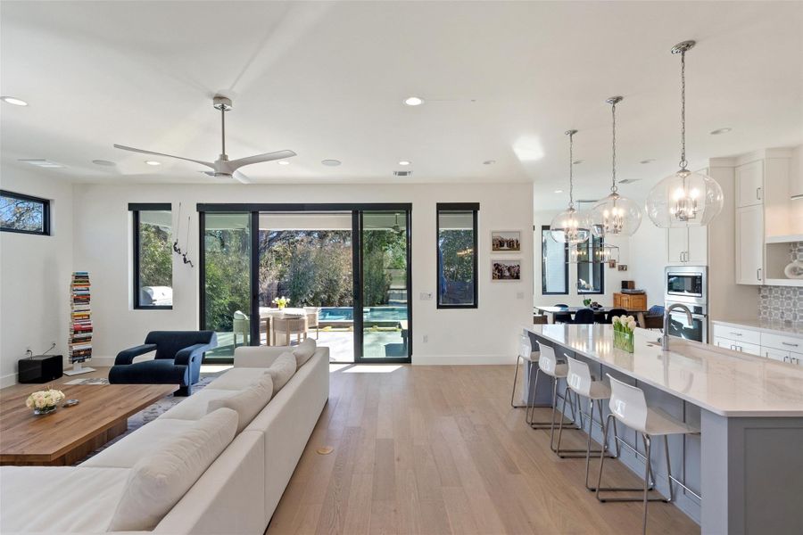 Fleetwood sliding glass doors give this living room an indoor-outdoor feel, making this already spacious layout seem even bigger. Control the indoor/outdoor surround sound, lighting, pool and shades from your phone using the Smart Home System app.