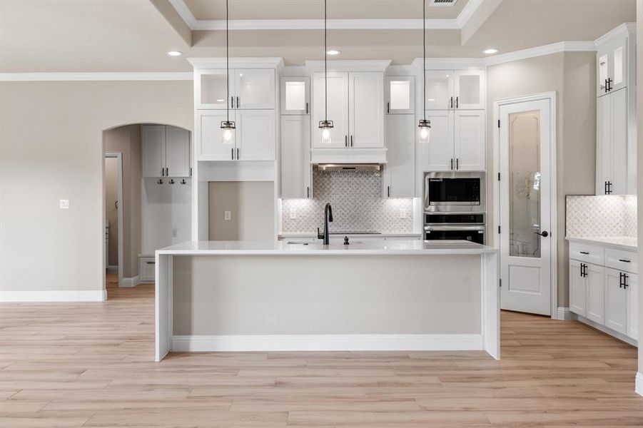 Light and bright kitchen with lighted glass upper cabinets, soft closing drawers, and waterfall island! Light and bright kitchen with lighted glass upper cabinets, soft closing drawers, and waterfall island!