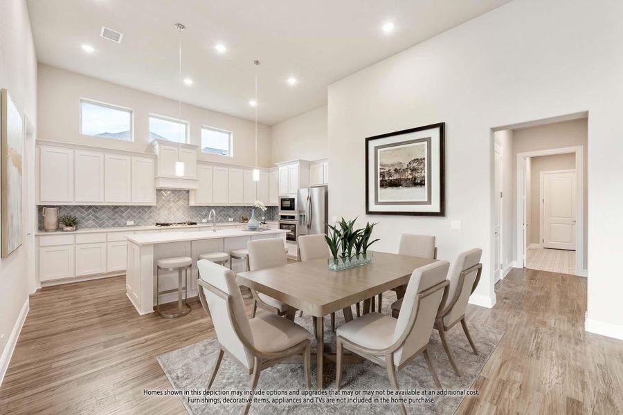 Open-concept dining area and kitchen with white cabinets, herringbone backsplash, and hardwood floors Open-concept dining area and kitchen with white cabinets, herringbone backsplash, and hardwood floors