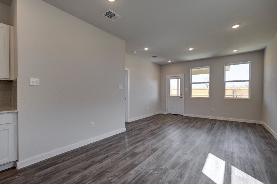A room with a wood floor and white walls.