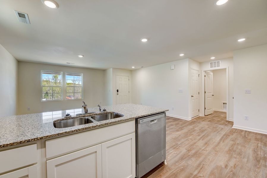 A kitchen with white cabinets.