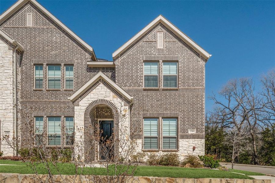 View of front of property with brick siding and stone siding