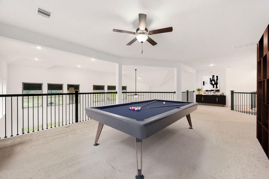 The upstairs game room offers an open layout, views overlooking the main living area, and flexible space for a variety of uses.
